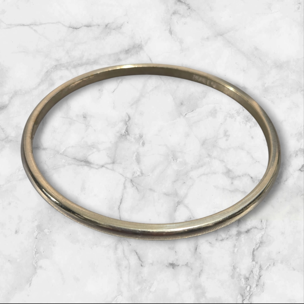 VIntage Monet silver-tone bangle bracelet with a sleek, minimalist design.